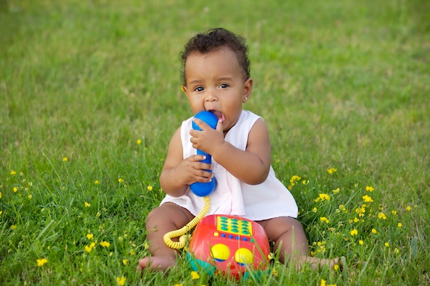 Adorable little black girl with big phone