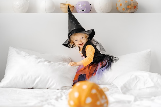 Adorable little blond girl ready for trick-or-treat. halloween, holiday and childhood concept.