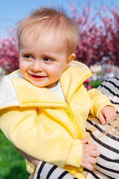 An adorable little boy in his mom39s arms