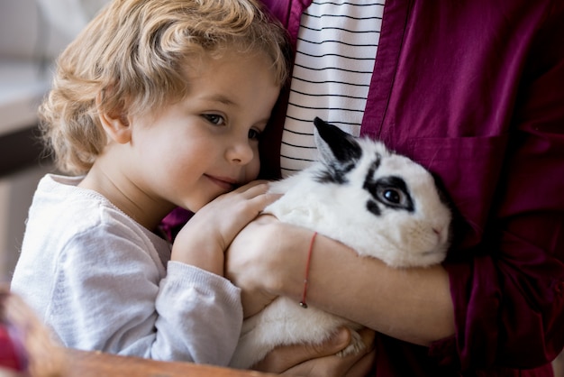 Foto adorabile ragazzino che abbraccia il coniglietto