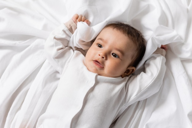 adorable little boy laying on blanket card banner health