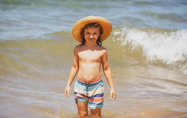 Premium Photo  Adorable little boy in straw hat at beach during