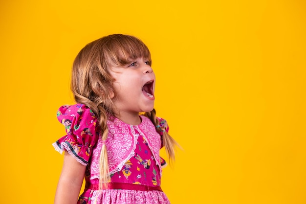 Adorable little caucasian girl wearing typical clothes for Festa Junina