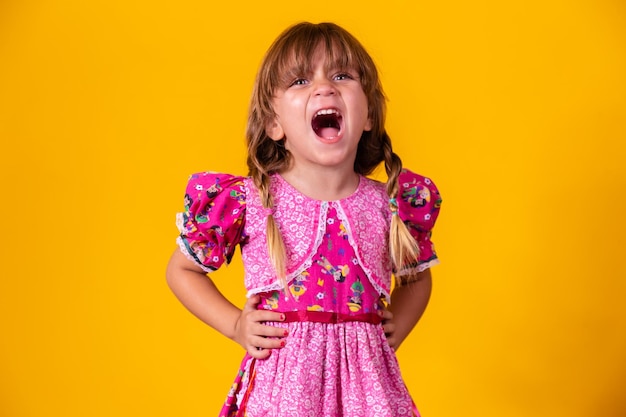 Adorable little caucasian girl wearing typical clothes for Festa Junina