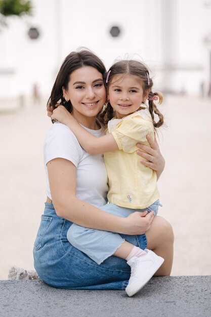 Adorable little daughter hug her mom and smile beautiful happy family