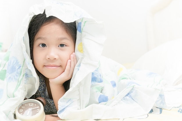 Adorable little girl awaked up in her bed