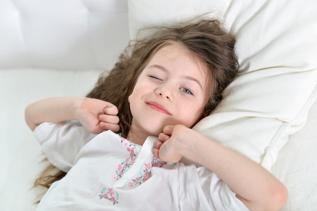 Adorable little girl awaked up in her bed