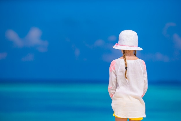 Adorable little girl at beach during summer vacation