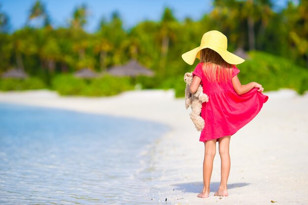 Adorable little girl at beach during summer vacation