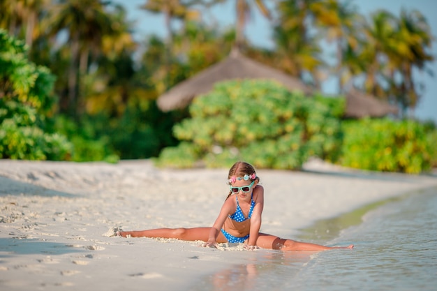 Adorable little girl at beach during summer vacation