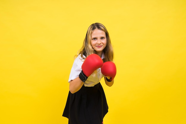 Adorable little girl boxer practicing punches in studio