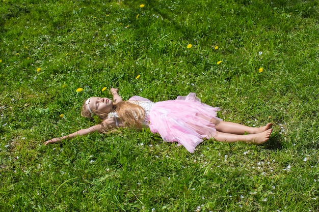 Adorable little girl have fun in blossoming apple orchard