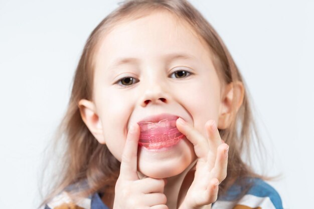 Adorable little girl puts myofunctional trainer in the mouth