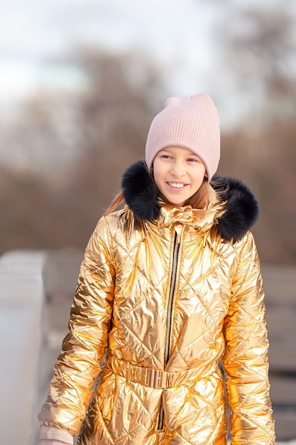 Adorable little girl skating on the ice-rink