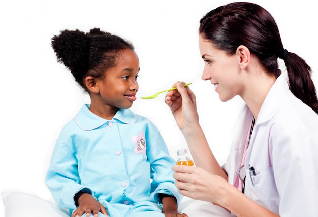 Adorable little girl taking medicine 