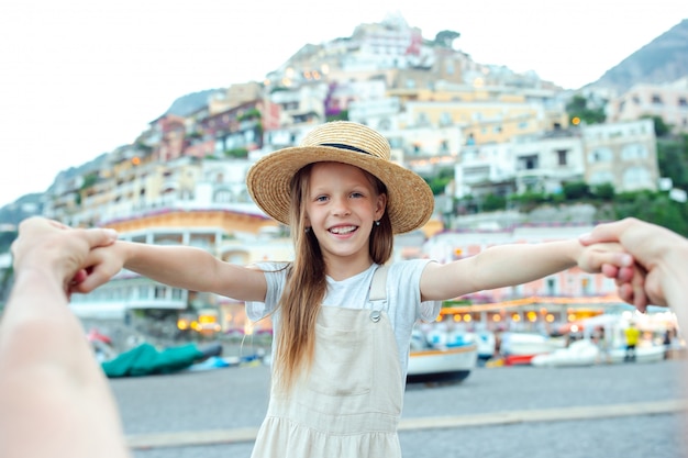 Adorable little girl on warm and sunny summer day in positano town in italy