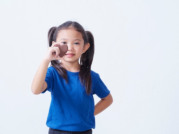 Adorable little girl with heart-shaped chocolate isolated