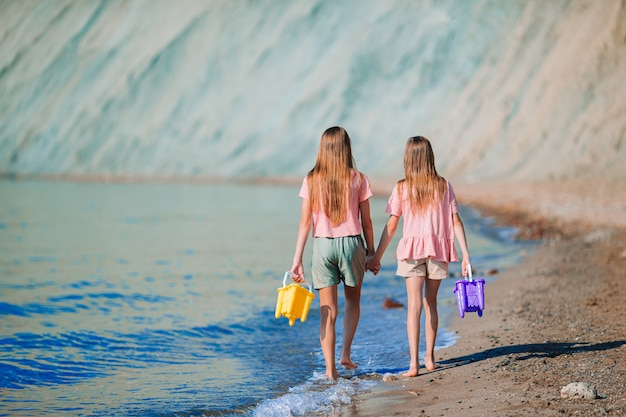 Adorable little girls having fun on the beach