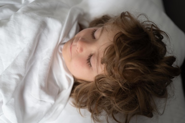 Adorable little kids sleeping in bed good morning