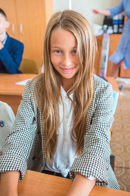 Adorable little school girl with notes and pencils indoor