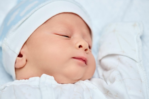 Adorable new born baby sleeping in bed