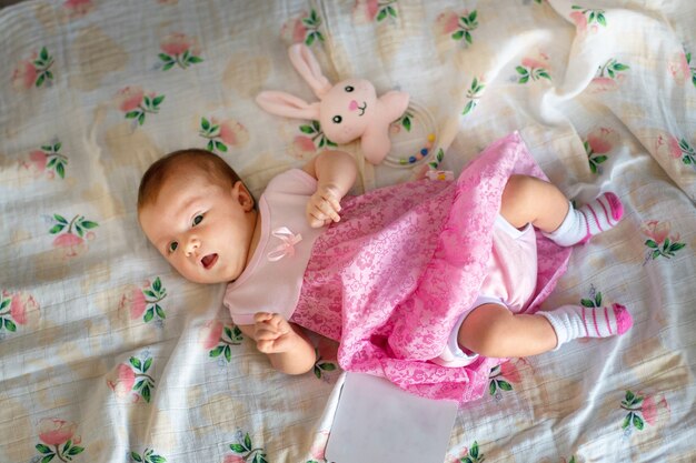 Adorable newborn baby girl in pink dress