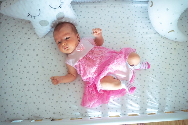 Adorable newborn baby girl in pink dress