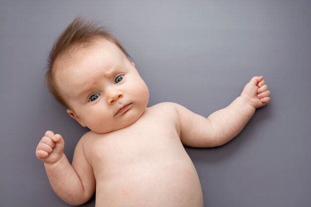 Adorable newborn baby on gray background