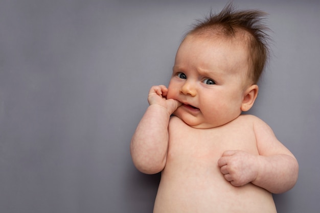 Adorable newborn baby on gray background