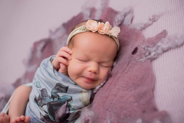 Adorable newborn baby sleeping in cozy room Cute happy infant baby portrait with sleepy face