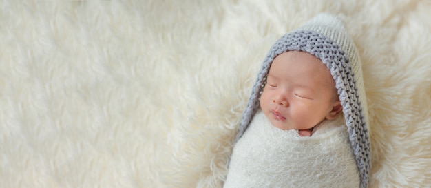 Adorable newborn baby sleeping in cozy room.