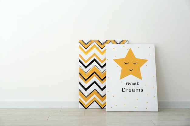 Adorable pictures of zigzag pattern and star with words SWEET DREAMS on floor near white wall space for text Children39s room interior elements