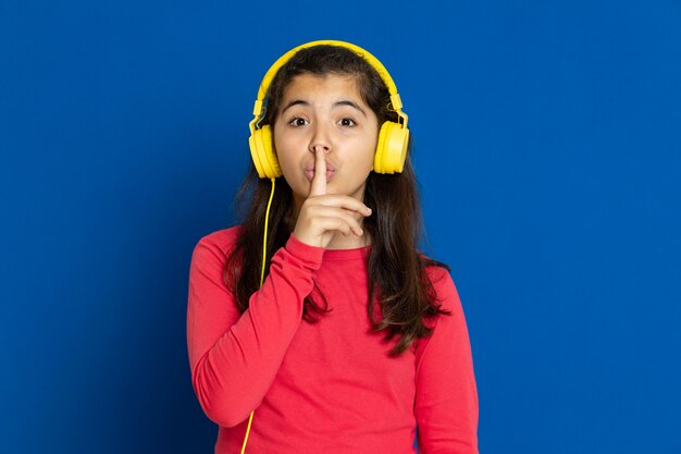 Adorable preteen girl with red jersey gesturing over blue wall