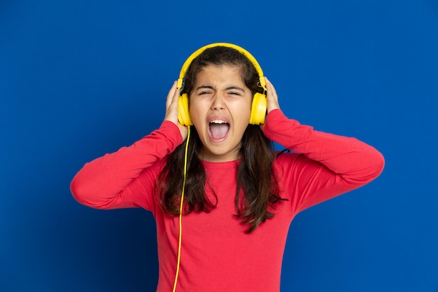 Adorable preteen girl with red jersey gesturing over blue wall