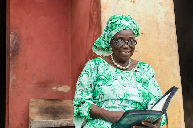 Adorable senior african woman wearing glasses smiling looking at camera