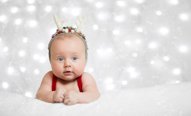 Adorable sleeping newborn baby wearing Santa Claus hat Christmas New Year