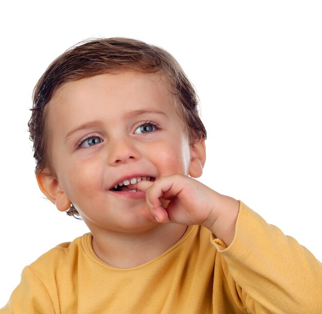 Adorable small child two years old sucking his hand isolated on a white background