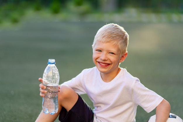 Adorable sporty child on the football field