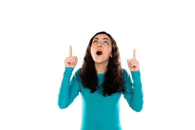 Adorable teenage girl with blue sweater isolated on a white wall