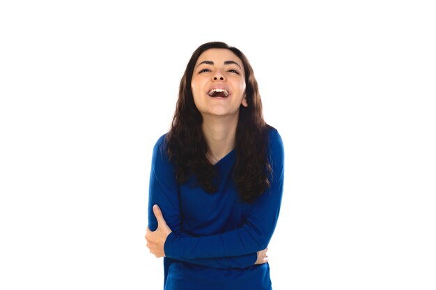 Adorable teenage girl with blue sweater isolated on a white wall