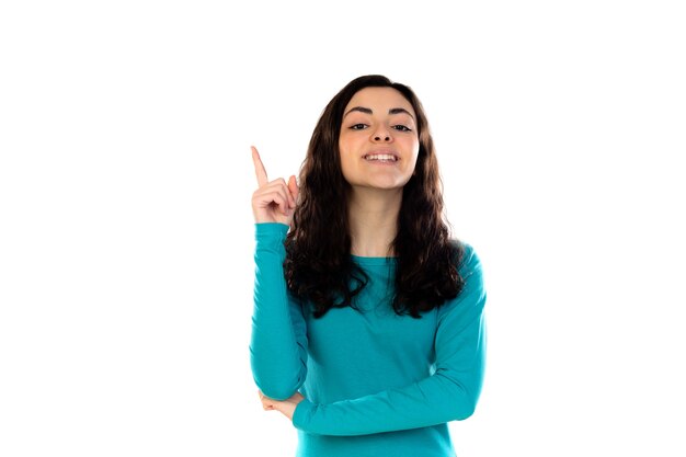 Adorable teenage girl with blue sweater isolated on a white wall