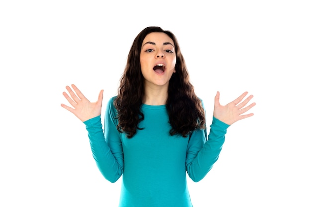 Adorable teenage girl with blue sweater isolated on a white wall