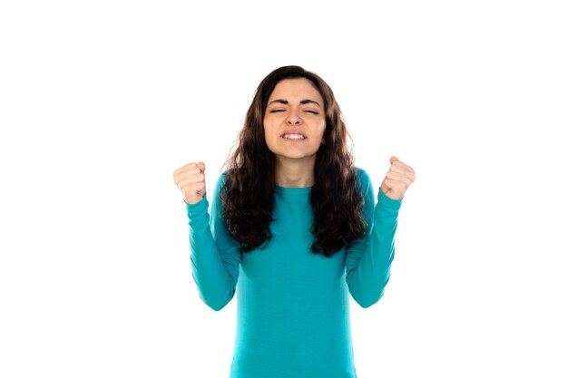 Adorable teenage girl with blue sweater isolated on a white wall