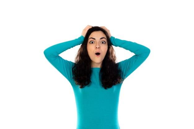 Adorable teenage girl with blue sweater isolated on a white wall