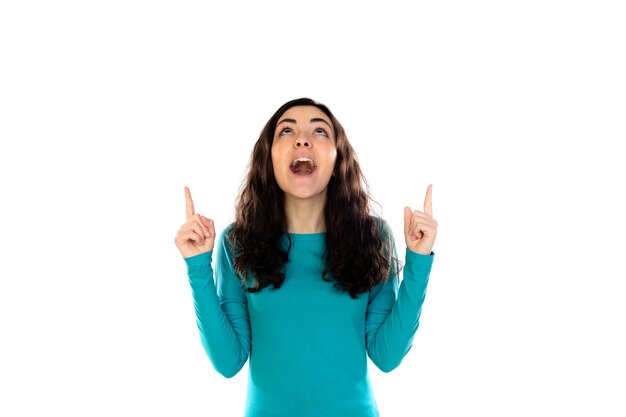 Adorable teenage girl with blue sweater isolated on a white wall