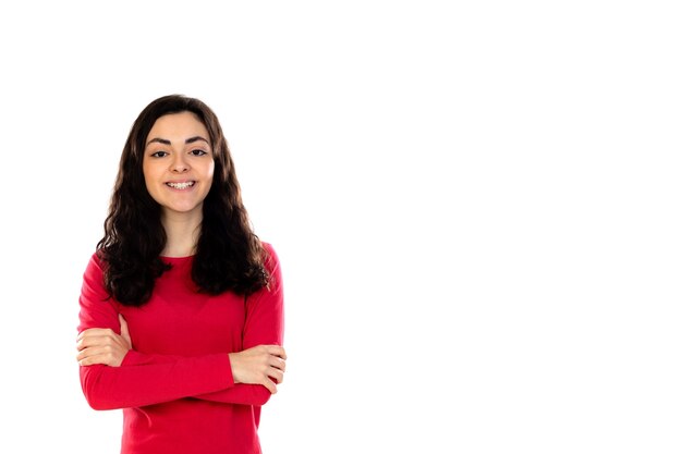 Adorable teenage girl with red sweater isolated on a white wall