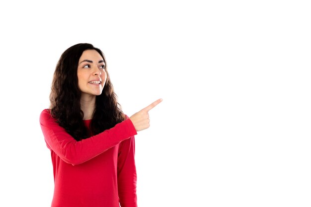 Adorable teenage girl with red sweater isolated on a white wall