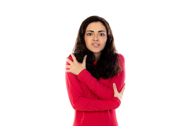 Adorable teenage girl with red sweater isolated on a white wall