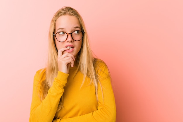 Adorable teenager woman relaxed thinking about something looking at a copy space.