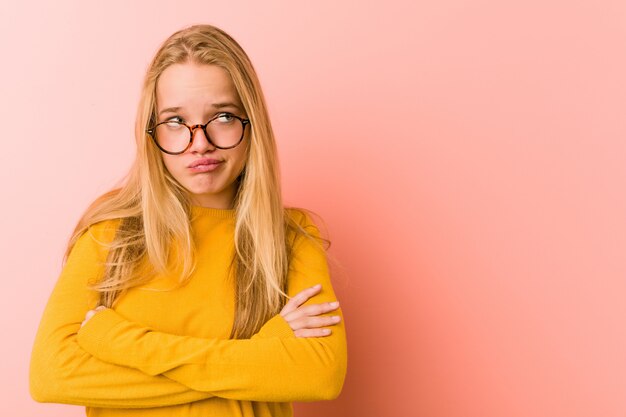 Adorable teenager woman unhappy in camera with sarcastic expression